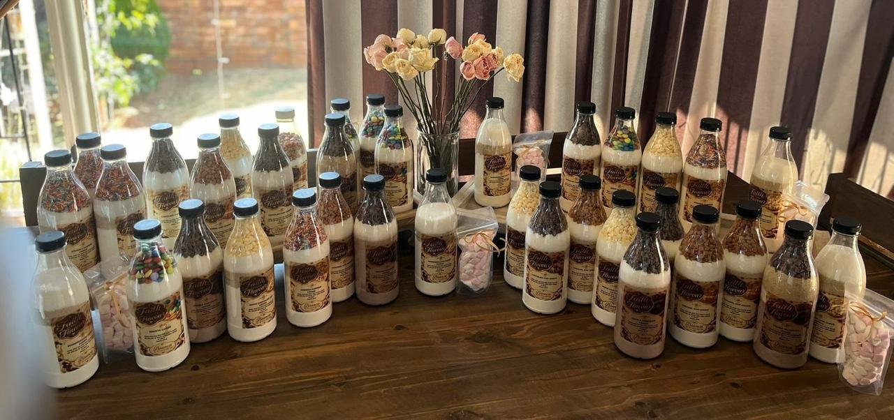 The full Faith in Every Flavour range of layered cookie mix bottles arranged together