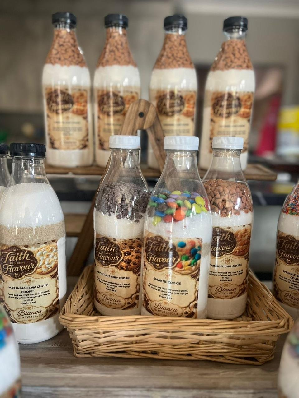 Rolling cookie dough beside layered cookie mix jars